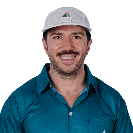 Man wearing a teal FRST shirt and white cap with the FRST logo on a white background