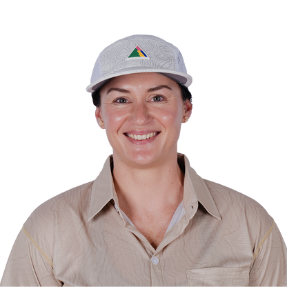 Person wearing a cap with FRST logo on a white background