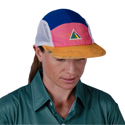 Person wearing a colorful cap with a triangle logo on a white background