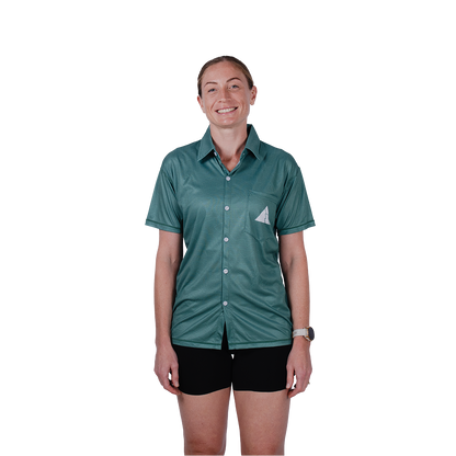 Person wearing a green shirt with a logo on a white background