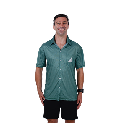 Man wearing a teal button-up shirt with a logo on a white background
