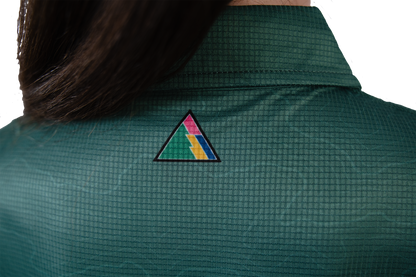Green shirt with a colourful triangle FRST logo on the back