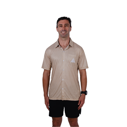 Man wearing a beige short-sleeve shirt with a logo on a white background